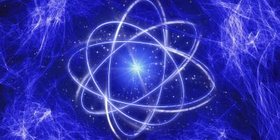 Abstract image of an atom-like structure with glowing orbits against a dynamic blue energy field background.