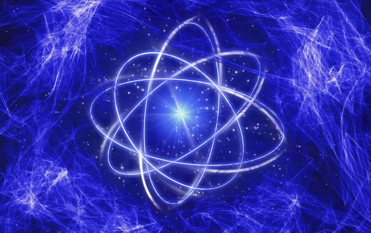 Abstract image of an atom-like structure with glowing orbits against a dynamic blue energy field background.