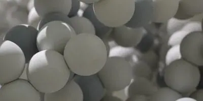 Close-up view of a molecular model consisting of interconnected spherical elements in shades of gray and white.
