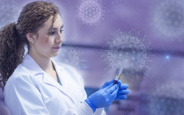 Female scientist in a digital lab examining a test sample with graphical COVID-19 virus representations in the background.