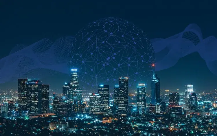 Night view of a city skyline with interconnected digital network graphics overlay, representing a connected smart city with advanced technology and communication systems.
