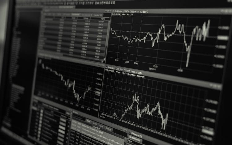 Black and white display of stock market data with multiple charts and graphs showing market trends and statistics.