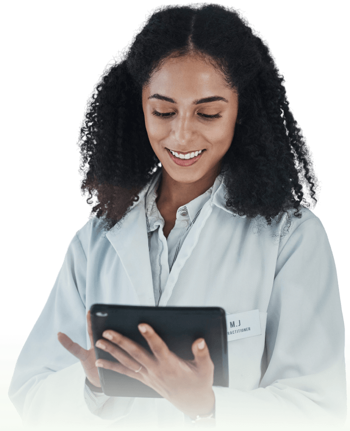 A female scientist in a lab coat smiles while reviewing data on a tablet.