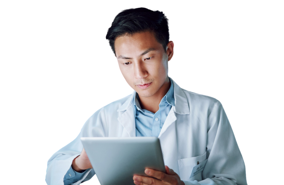 A scientist in a lab coat examines data on a tablet.