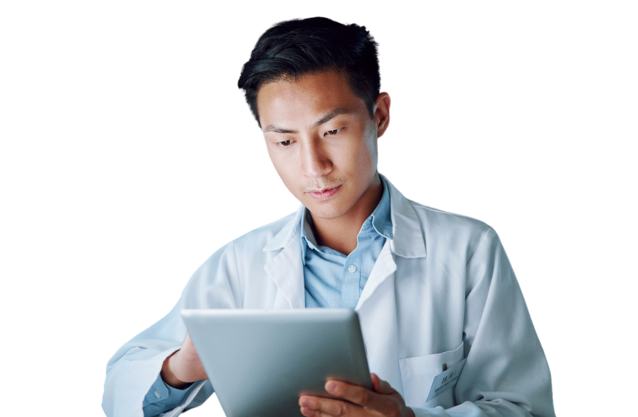 A scientist in a lab coat examines data on a tablet.