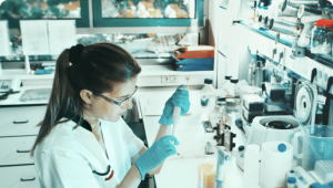 Female scientist conducting experiments in a well-equipped lab.