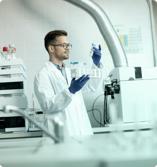 Scientist examining a sample vial in a modern lab environment.